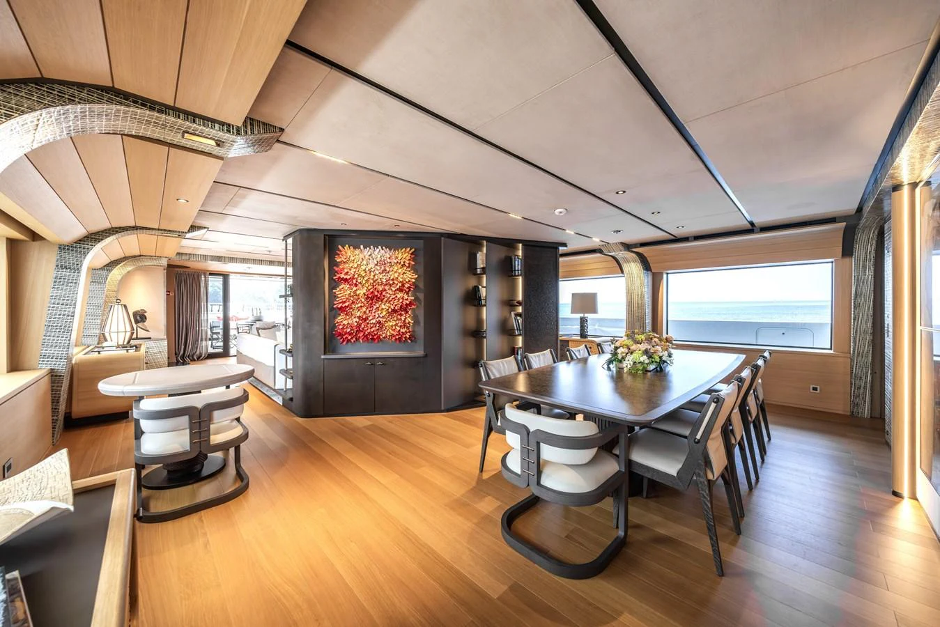 The yacht's dining area features a modern design with ample natural light and elegant furnishings. aboard AKULA Yacht for Sale