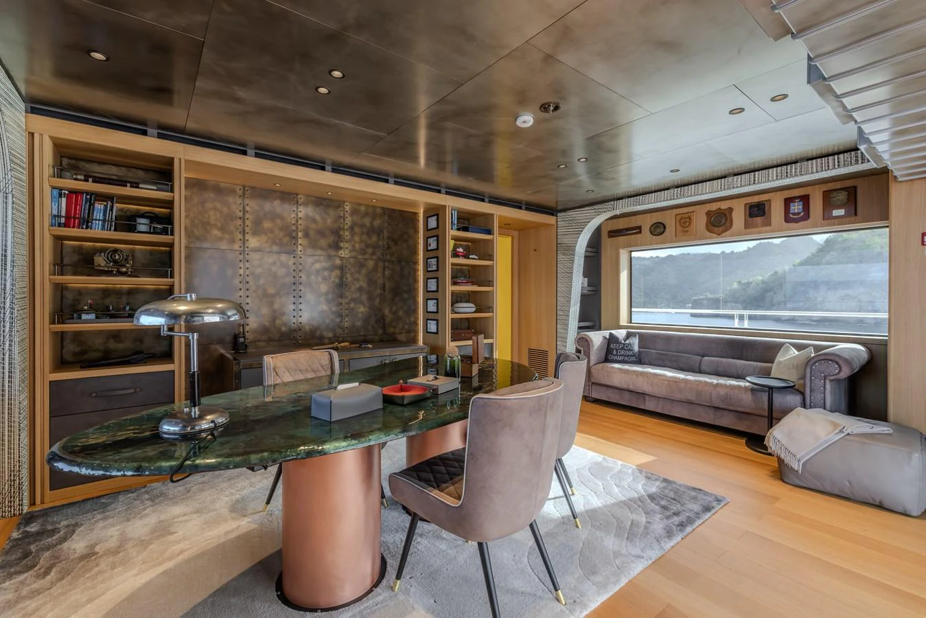 The yacht's office features a luxurious desk, comfortable seating, and ample natural light from large windows. aboard AKULA Yacht for Sale