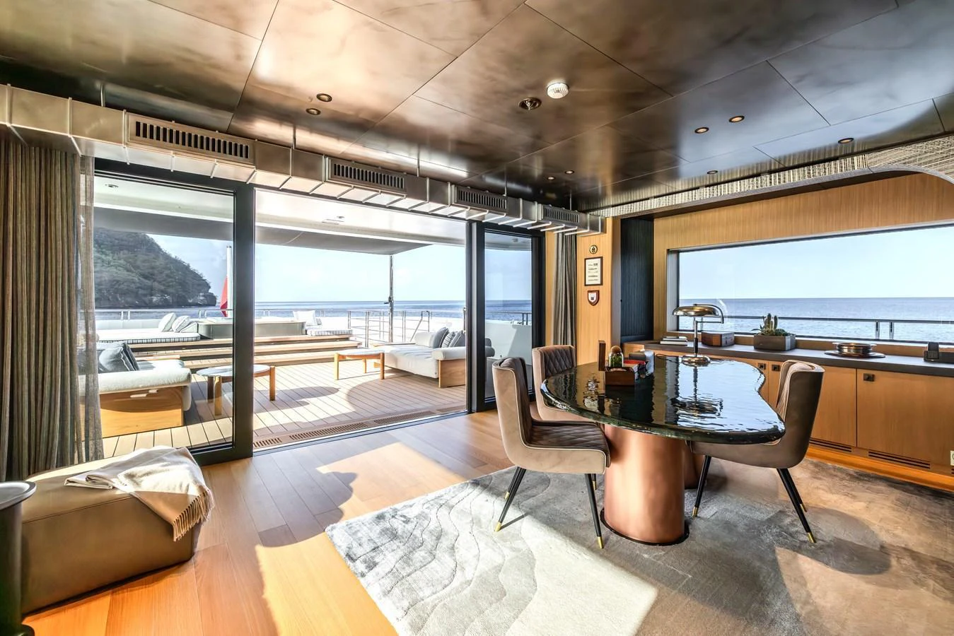 The salon offers a luxurious and spacious area with stunning ocean views and modern furnishings. aboard AKULA Yacht for Sale
