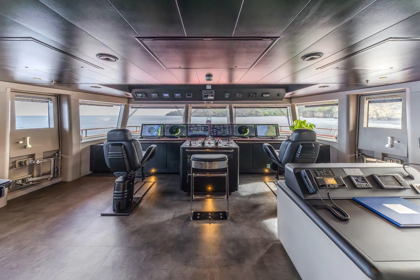 The helm station offers a commanding view with state-of-the-art navigation equipment and luxurious seating. aboard AKULA Yacht for Sale