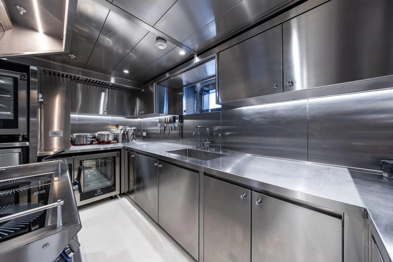 The yacht's galley features sleek stainless steel surfaces and modern appliances, providing a professional-grade cooking environment. aboard AKULA Yacht for Sale