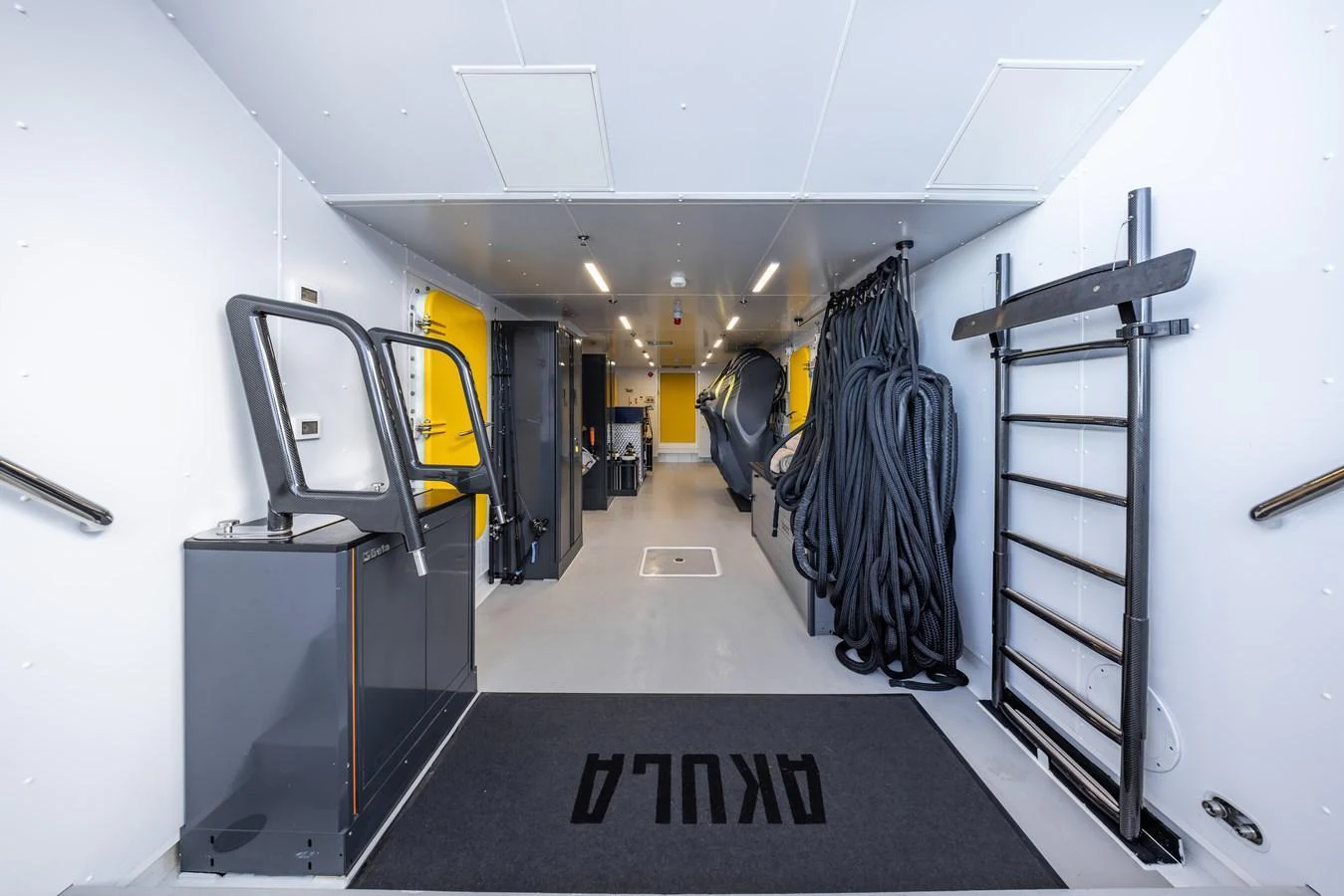 A spacious and well-organized storage area with various equipment and gear neatly arranged. aboard AKULA Yacht for Sale