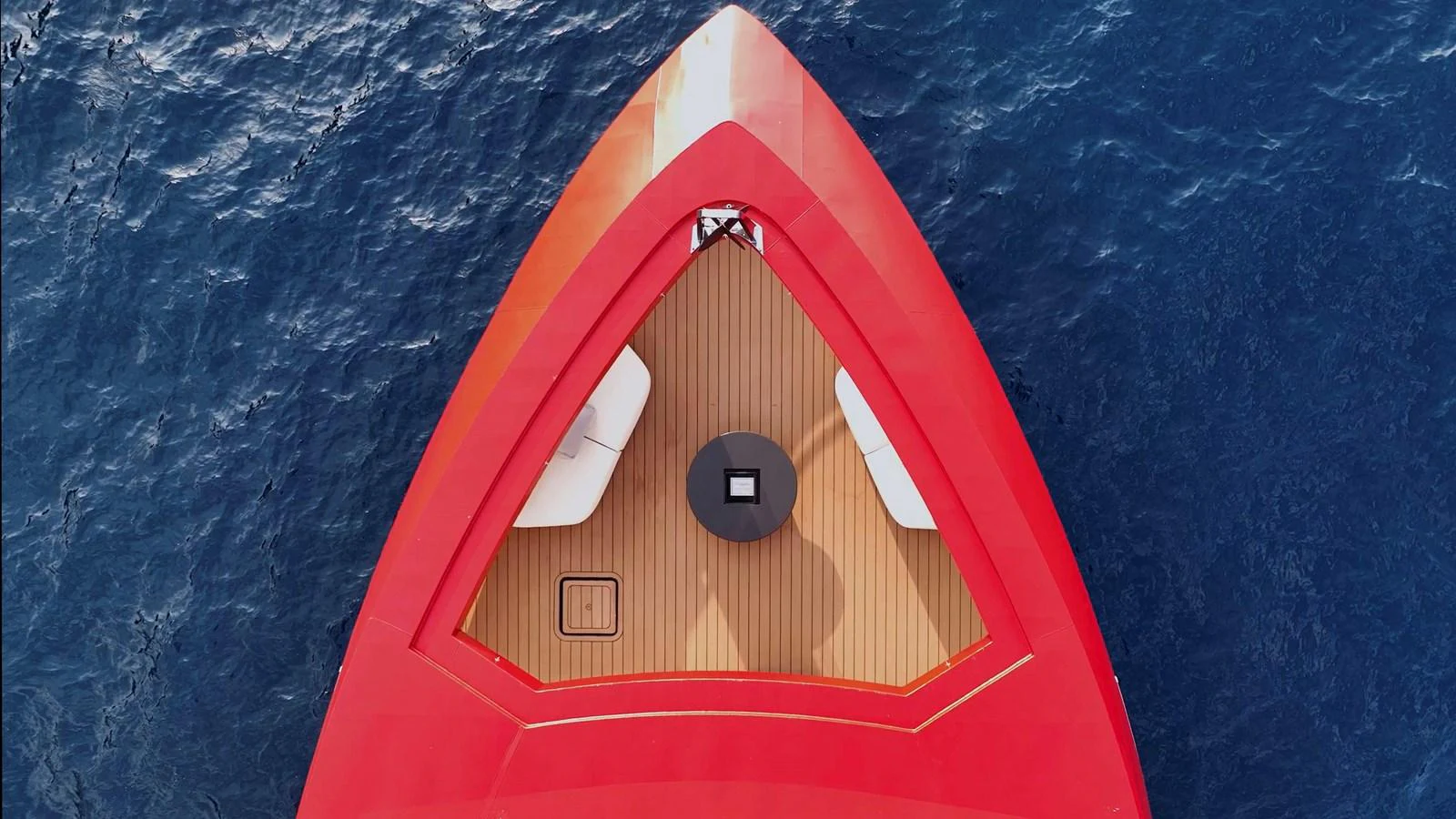 The striking red bow of the yacht contrasts beautifully with the deep blue sea. aboard AKULA Yacht for Sale