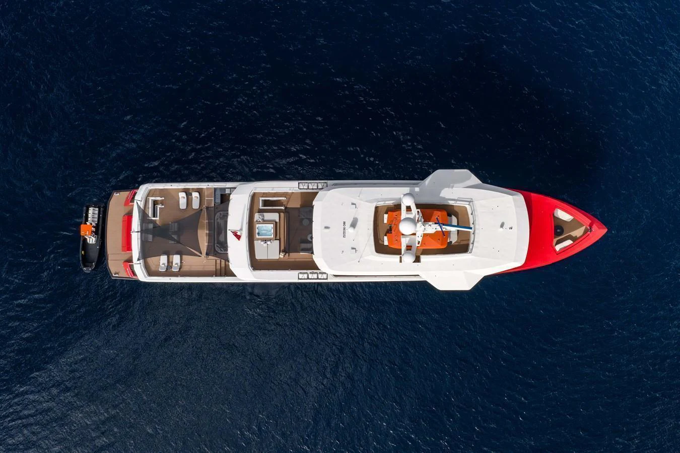 A stunning aerial view of a luxurious yacht cruising on deep blue waters. aboard AKULA Yacht for Sale