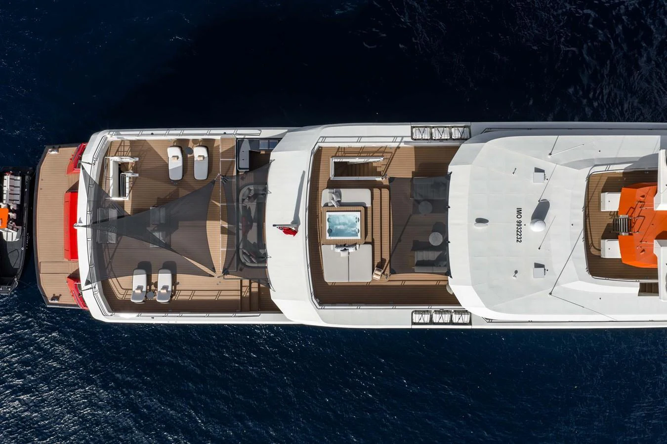Aerial view of a luxurious yacht showcasing its expansive sundeck and amenities. aboard AKULA Yacht for Sale