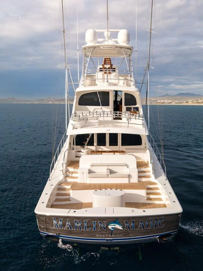 The yacht's aft deck showcases a spacious and inviting area for relaxation and entertainment. aboard MARLIN MAGIC Yacht for Sale