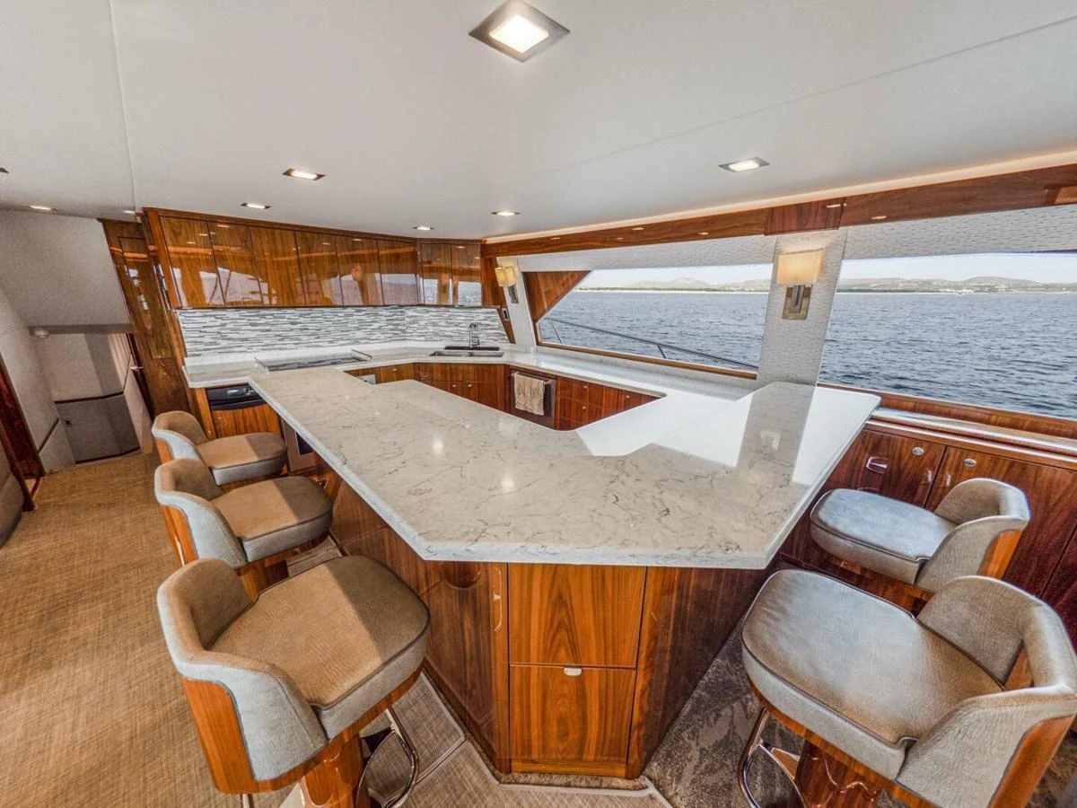 The galley features a spacious countertop with ample seating and panoramic views. aboard MARLIN MAGIC Yacht for Sale