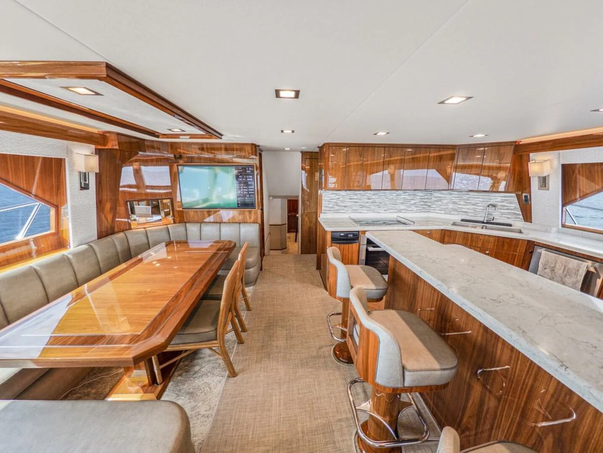 The yacht's galley features a spacious dining area and a well-equipped kitchen with modern amenities. aboard MARLIN MAGIC Yacht for Sale