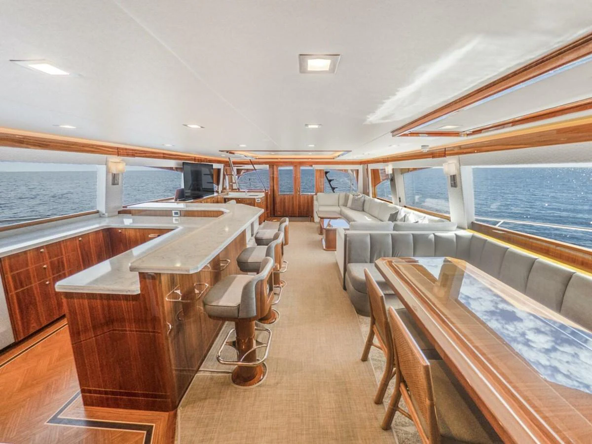 The salon offers a spacious and elegant area with ample seating and a well-appointed bar, perfect for relaxation and socializing. aboard MARLIN MAGIC Yacht for Sale