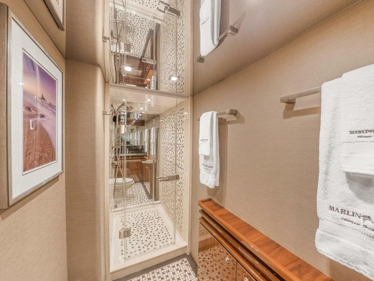 The yacht's bathroom features a modern shower with elegant tiling and luxurious amenities. aboard MARLIN MAGIC Yacht for Sale
