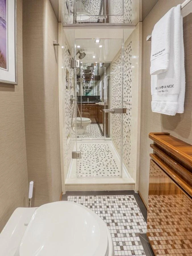 The yacht's bathroom features elegant tile work and modern fixtures. aboard MARLIN MAGIC Yacht for Sale