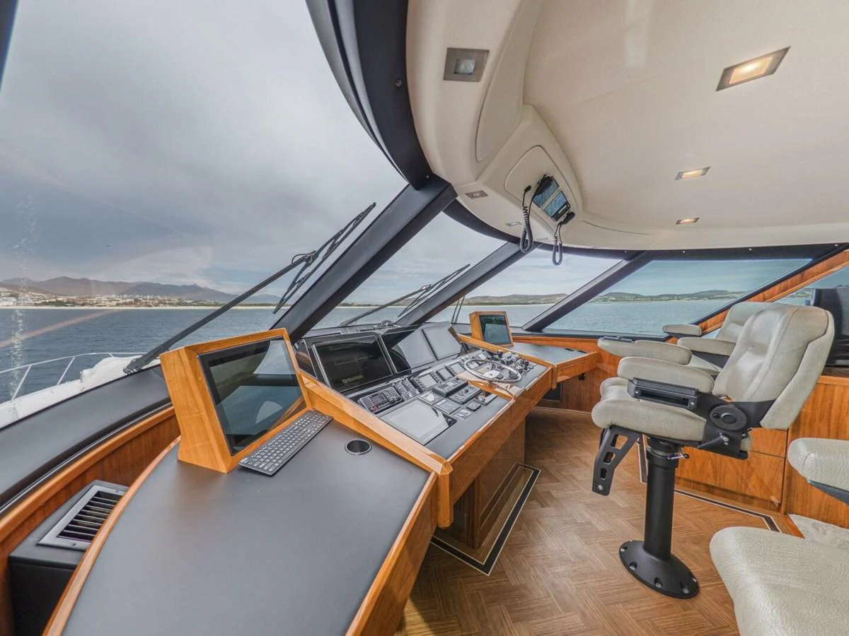 The helm station features advanced navigation equipment and luxurious seating with panoramic views. aboard MARLIN MAGIC Yacht for Sale