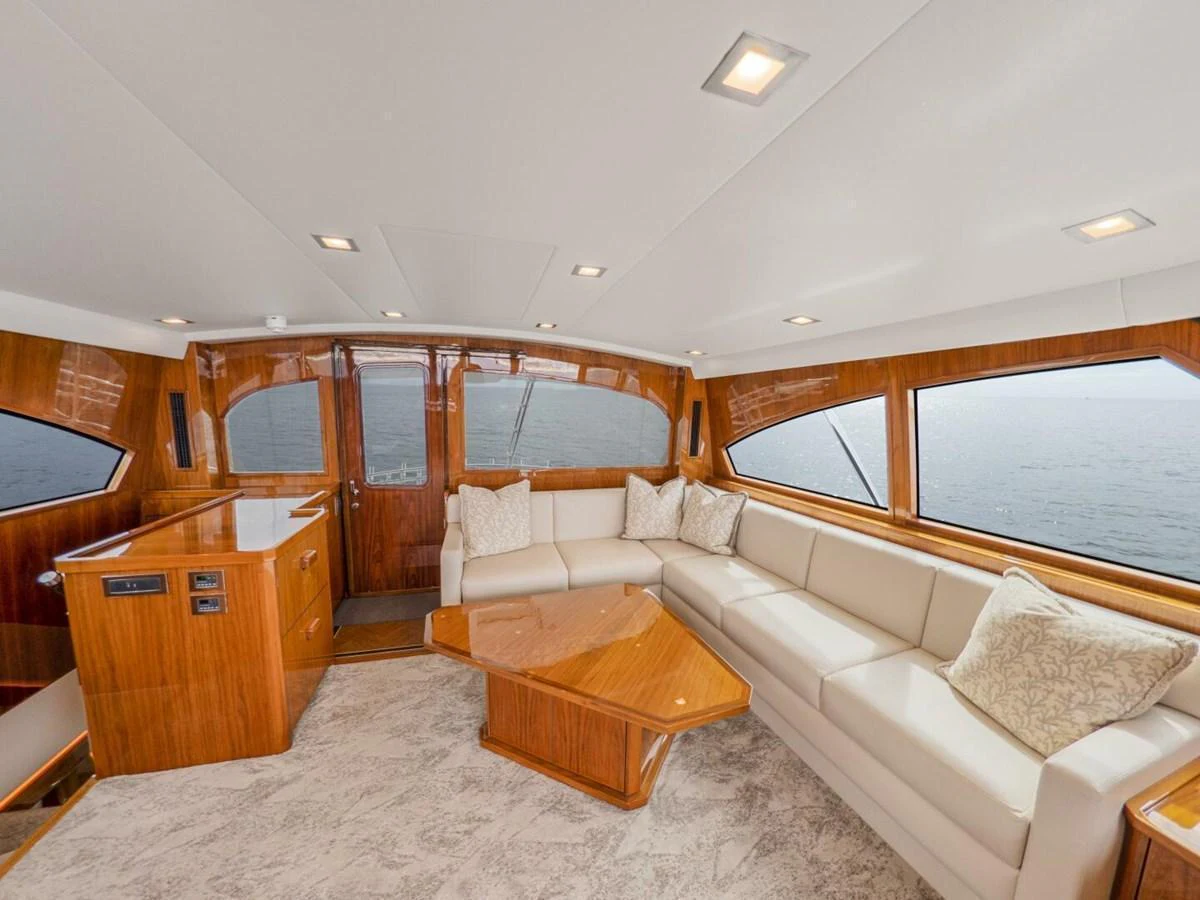 The salon features a spacious and elegant seating area with large windows offering panoramic views. aboard MARLIN MAGIC Yacht for Sale