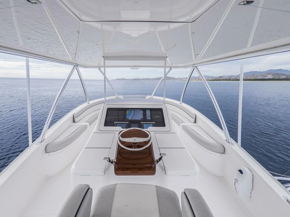 The helm area offers a sleek and modern design with panoramic views of the surrounding waters. aboard MARLIN MAGIC Yacht for Sale