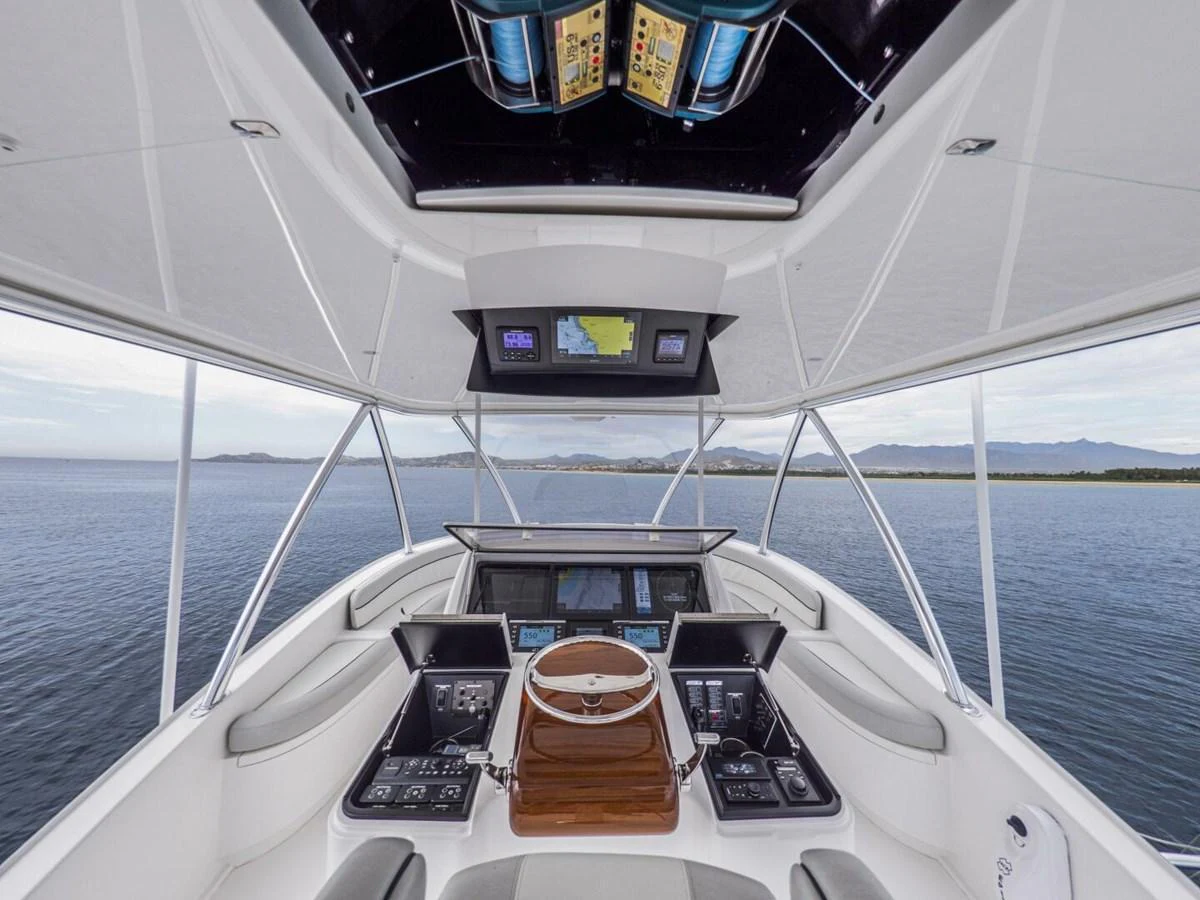 The helm station offers a commanding view with state-of-the-art navigation equipment and luxurious seating. aboard MARLIN MAGIC Yacht for Sale