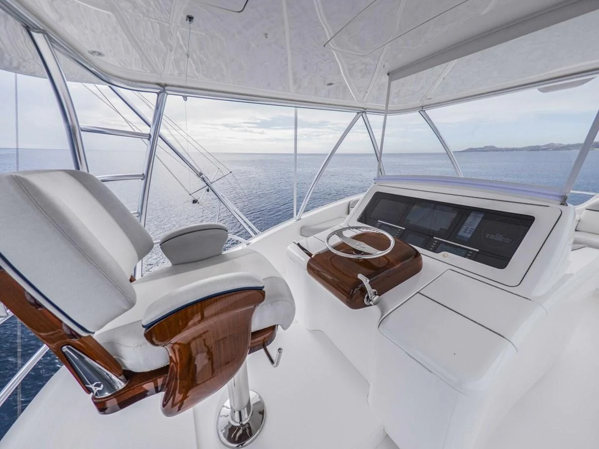 The helm station offers a commanding view with luxurious seating and state-of-the-art navigation equipment. aboard MARLIN MAGIC Yacht for Sale
