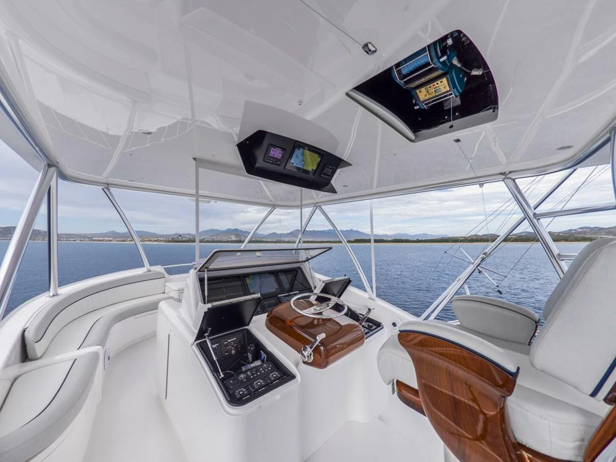 The helm station offers a commanding view with state-of-the-art navigation equipment and luxurious seating. aboard MARLIN MAGIC Yacht for Sale