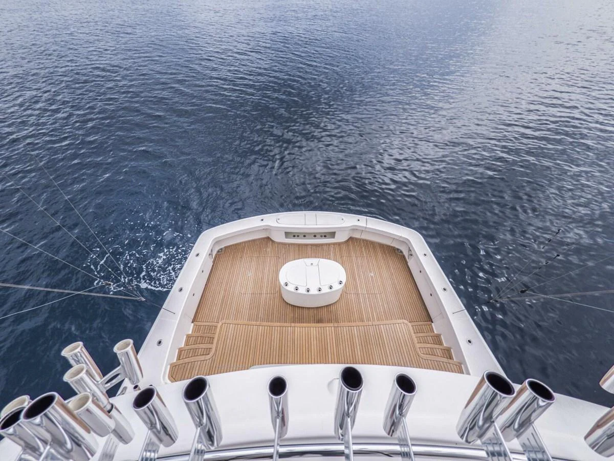The image captures the aft deck of a yacht with a view of the surrounding water. aboard MARLIN MAGIC Yacht for Sale