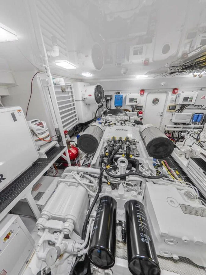 The image showcases a pristine and well-organized engine room with advanced machinery and equipment. aboard MARLIN MAGIC Yacht for Sale