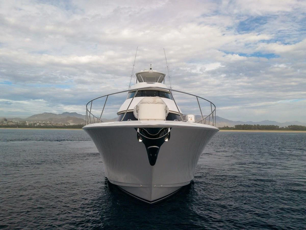 A sleek yacht is captured head-on, showcasing its impressive bow and modern design against a serene seascape. aboard MARLIN MAGIC Yacht for Sale