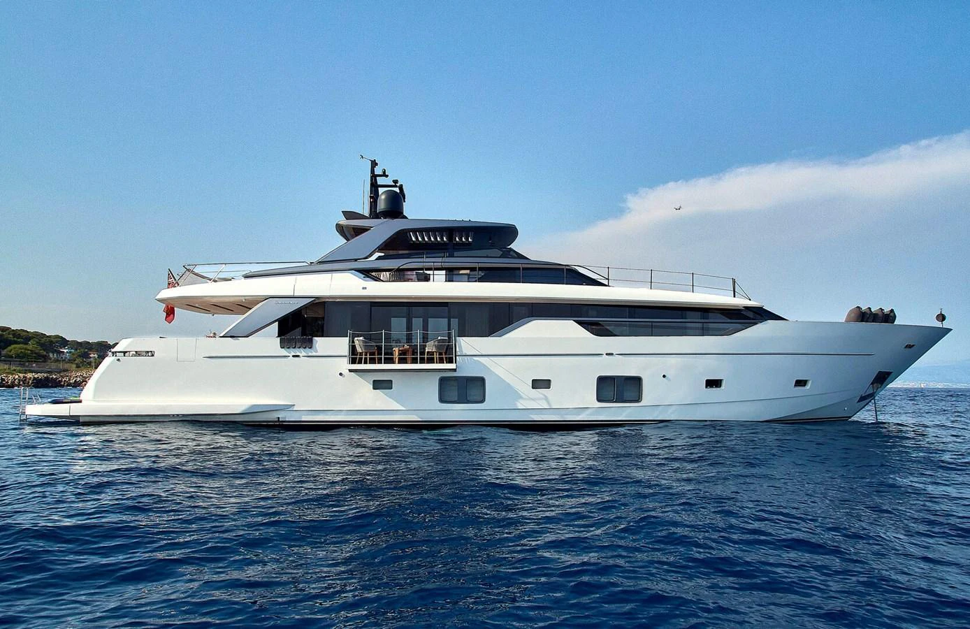 A sleek and modern yacht cruising on calm blue waters under a clear sky. aboard SANLORENZO SL102 ASYMMETRIC Yacht for Sale