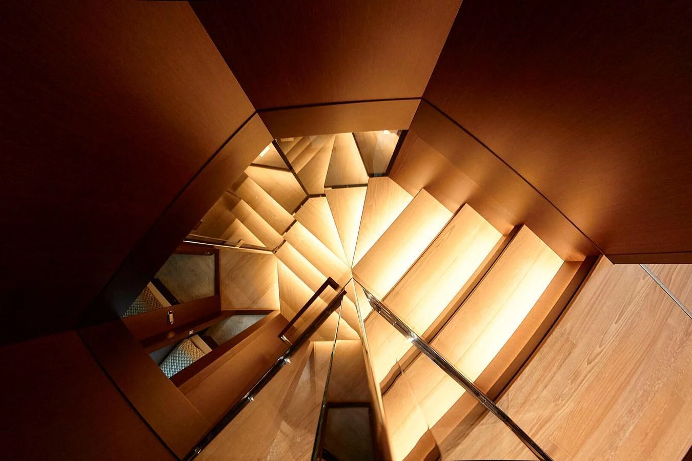 A beautifully designed wooden staircase with elegant lighting. aboard SANLORENZO SL102 ASYMMETRIC Yacht for Sale