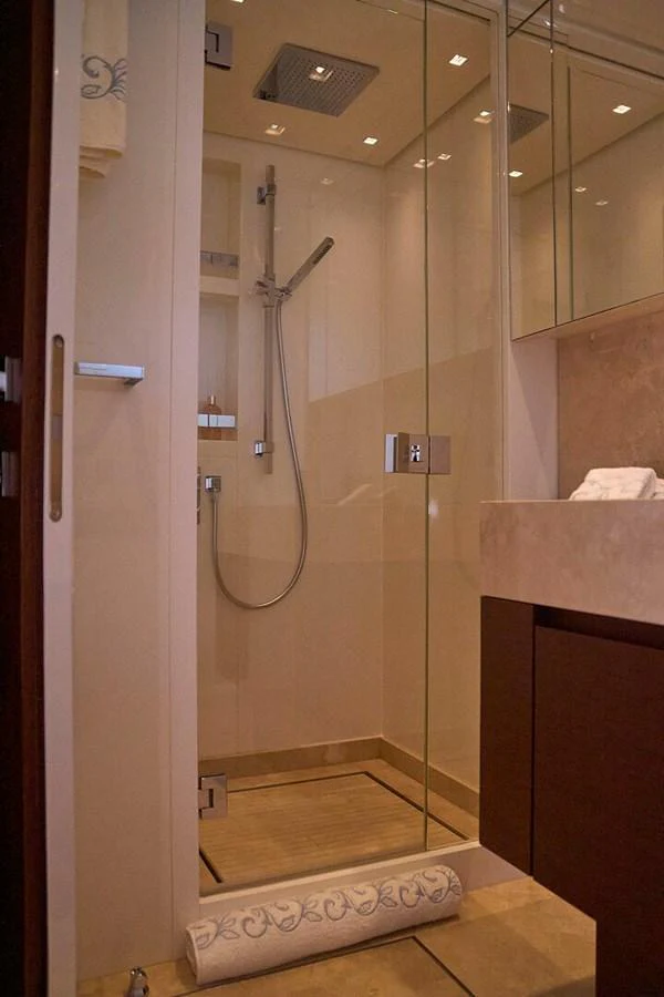 The yacht's bathroom features a modern glass-enclosed shower with elegant fixtures. aboard SANLORENZO SL102 ASYMMETRIC Yacht for Sale