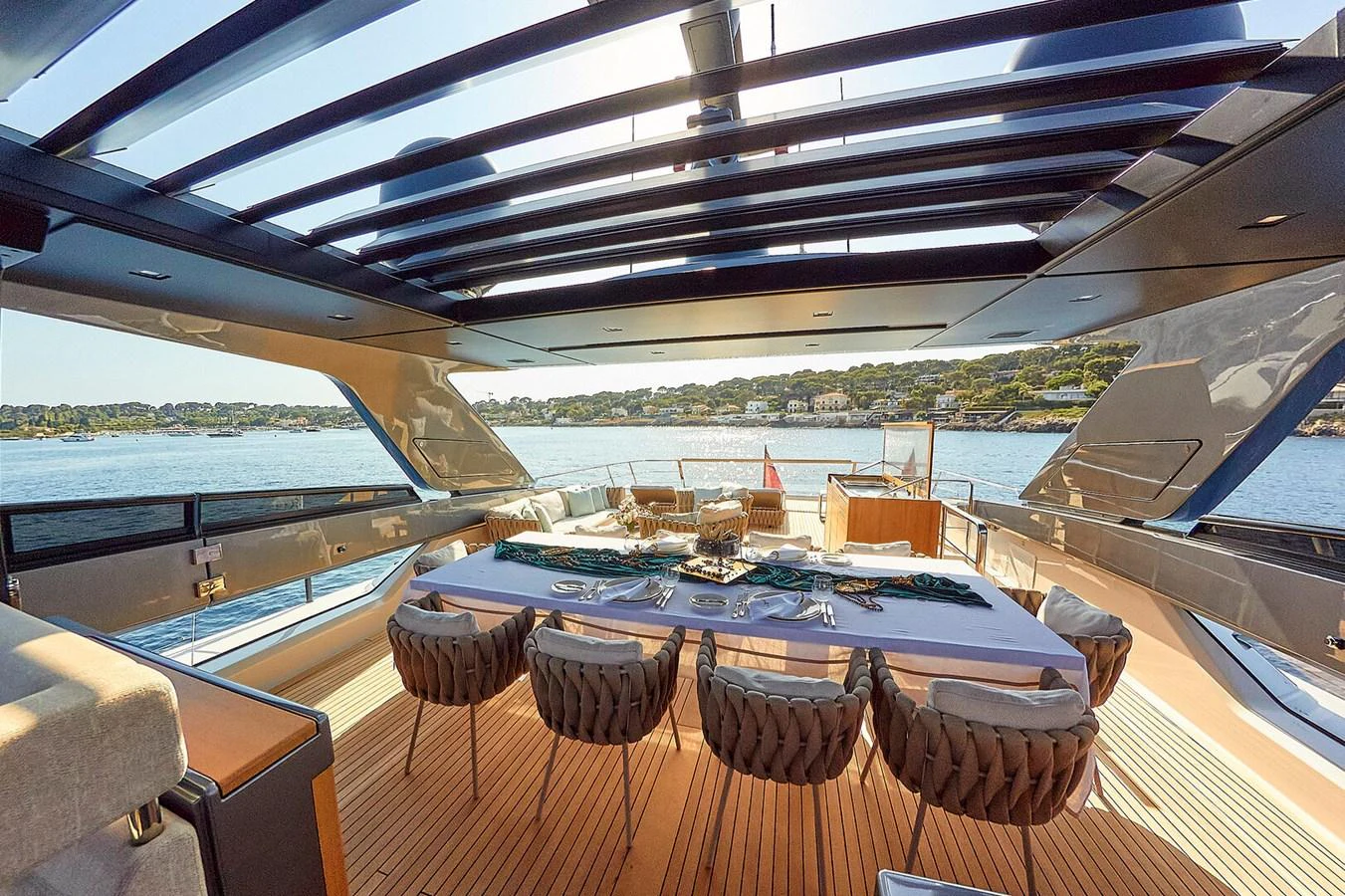 The aft deck features an elegant dining area with a stunning view of the water. aboard SANLORENZO SL102 ASYMMETRIC Yacht for Sale
