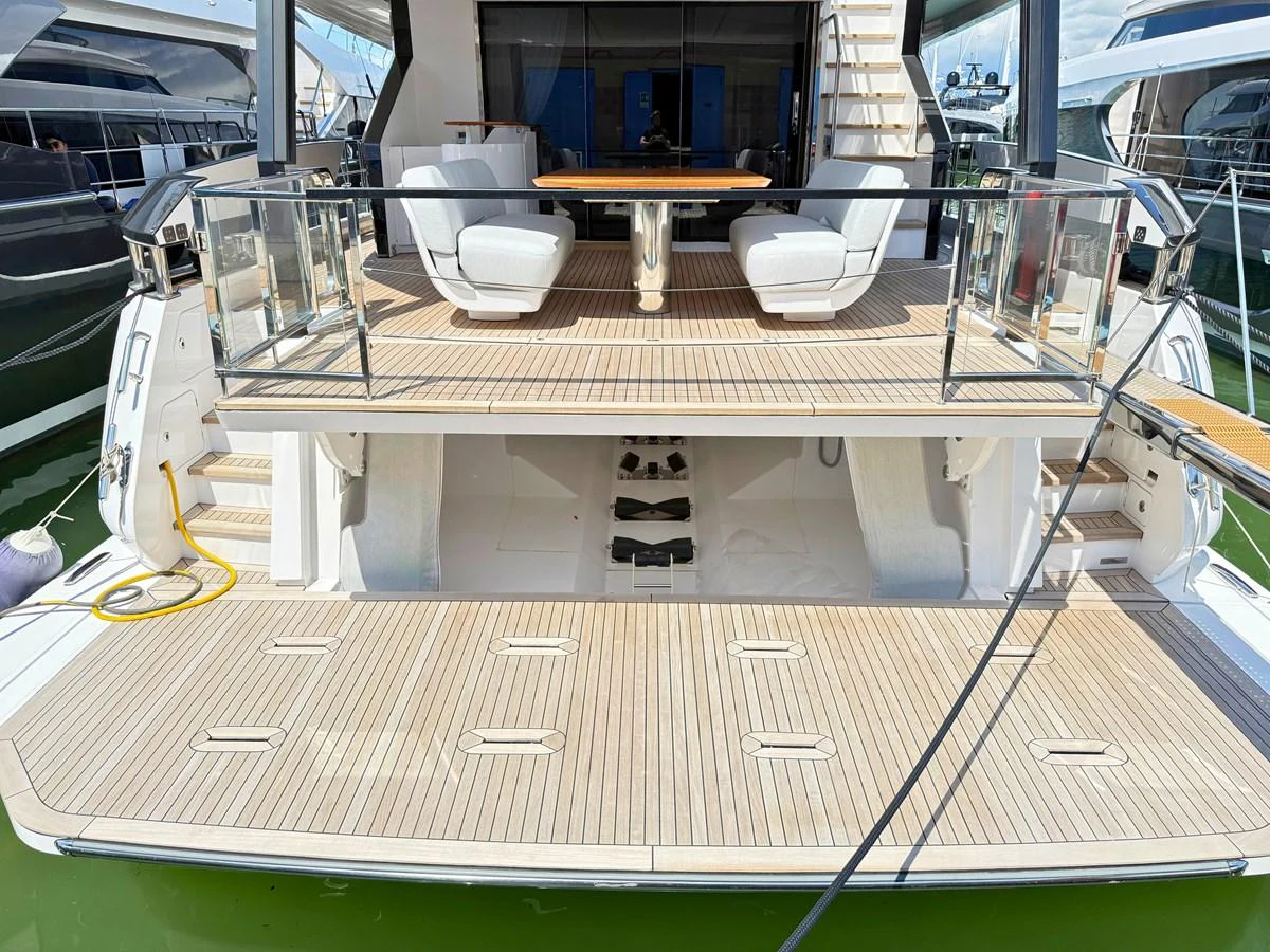 The yacht's aft deck features a spacious lounging area with elegant seating and a dining table, perfect for outdoor relaxation. aboard SEA STAR Yacht for Sale