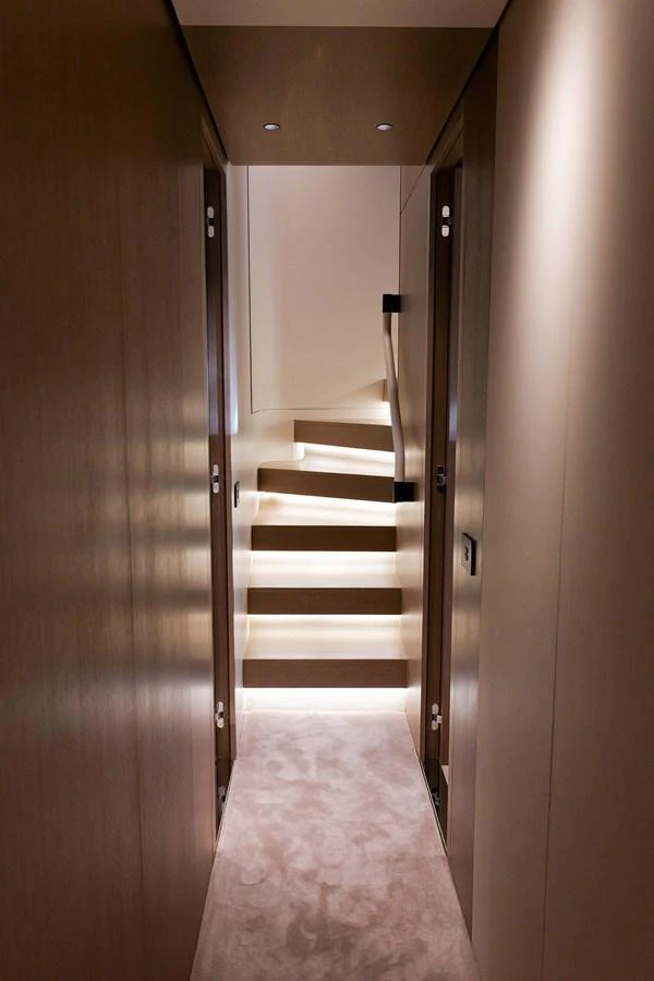 A sleek and modern staircase with ambient lighting leads to the upper deck. aboard SEA STAR Yacht for Sale