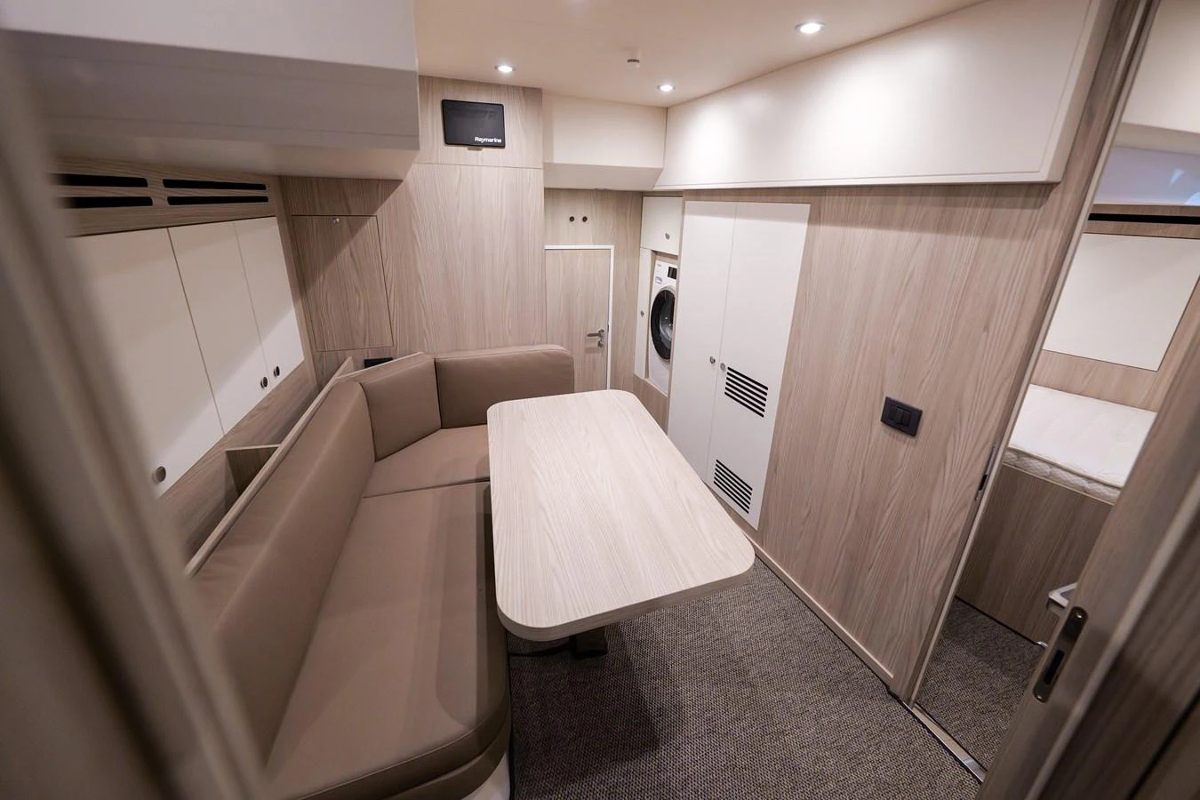 The crew quarters feature a cozy seating area with a table and built-in storage. aboard SEA STAR Yacht for Sale