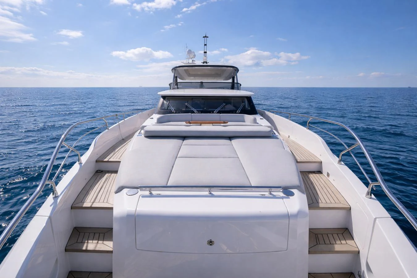 The yacht's foredeck offers a spacious sunbathing area with luxurious cushions and a panoramic view of the open sea. aboard SEA STAR Yacht for Sale