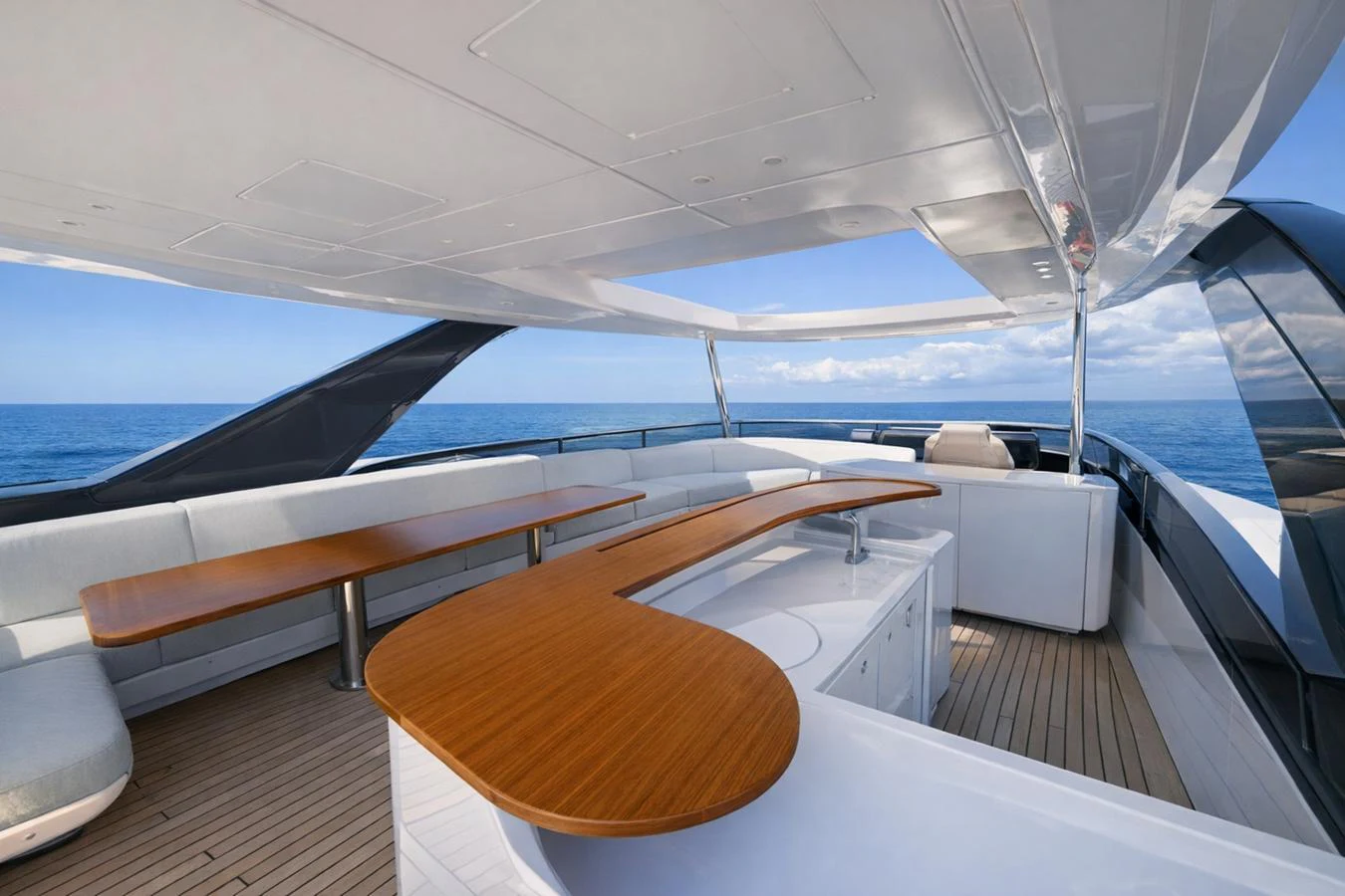 The flybridge offers a spacious and elegant area for relaxation and dining with stunning ocean views. aboard SEA STAR Yacht for Sale