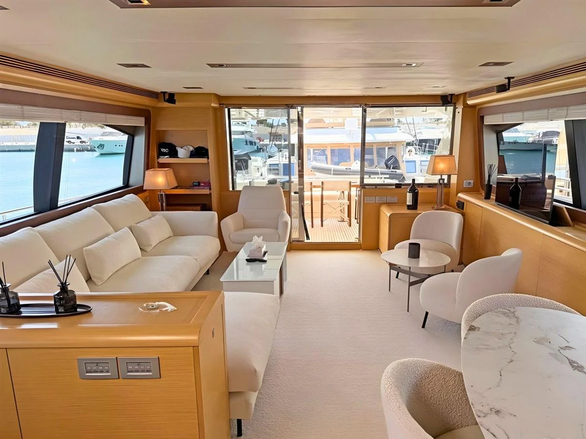 The salon features plush seating, elegant decor, and ample natural light through large windows. aboard M/Y ILAV Yacht for Sale
