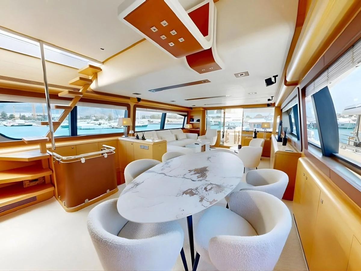 The yacht's saloon features a modern and spacious design with large windows and elegant furnishings. aboard M/Y ILAV Yacht for Sale