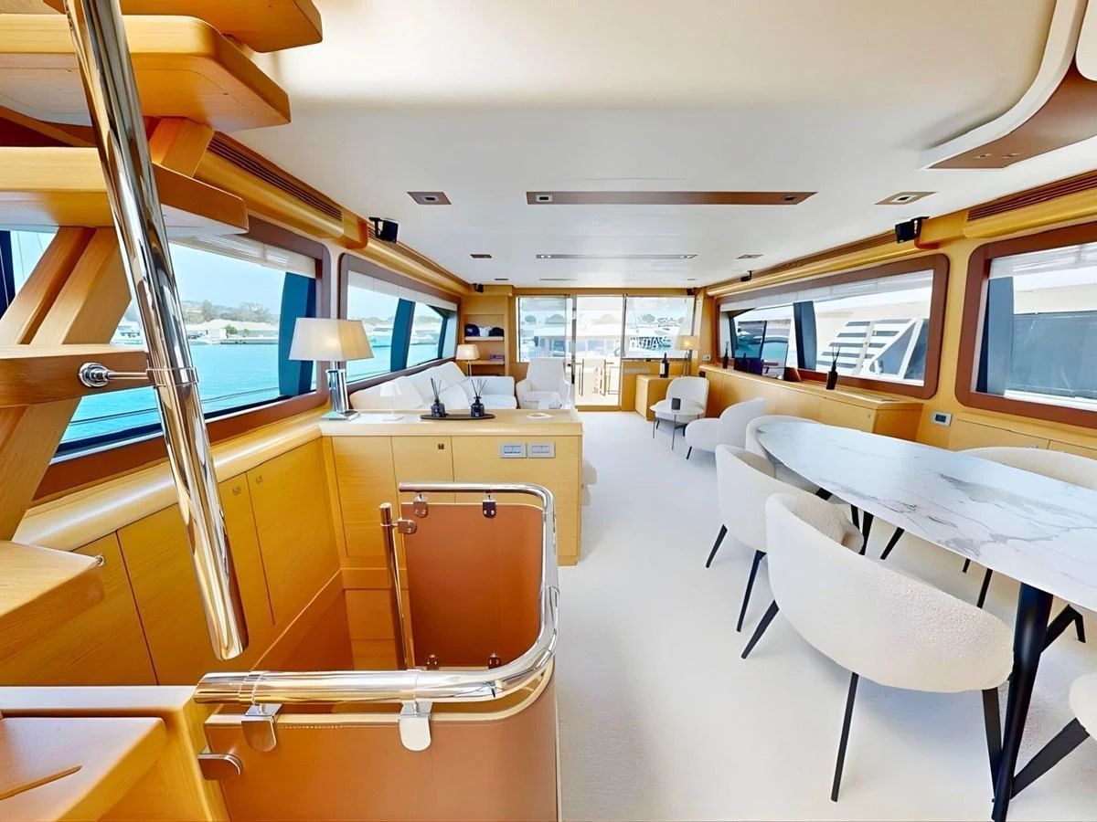 The salon offers a spacious and elegant area with ample seating and large windows for natural light. aboard M/Y ILAV Yacht for Sale
