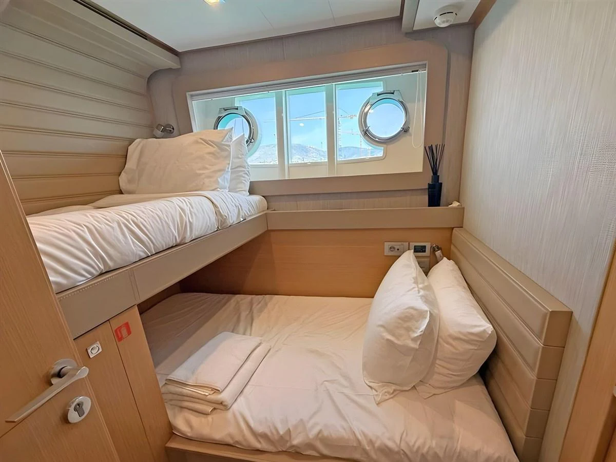 A cozy cabin with bunk beds and porthole windows offers a comfortable retreat. aboard M/Y ILAV Yacht for Sale