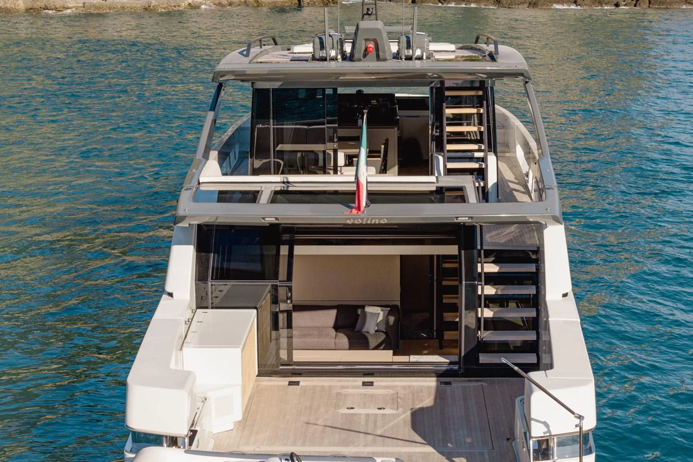 The yacht's aft deck showcases a spacious and modern design with ample seating and access to the water. aboard EOLINO Yacht for Sale