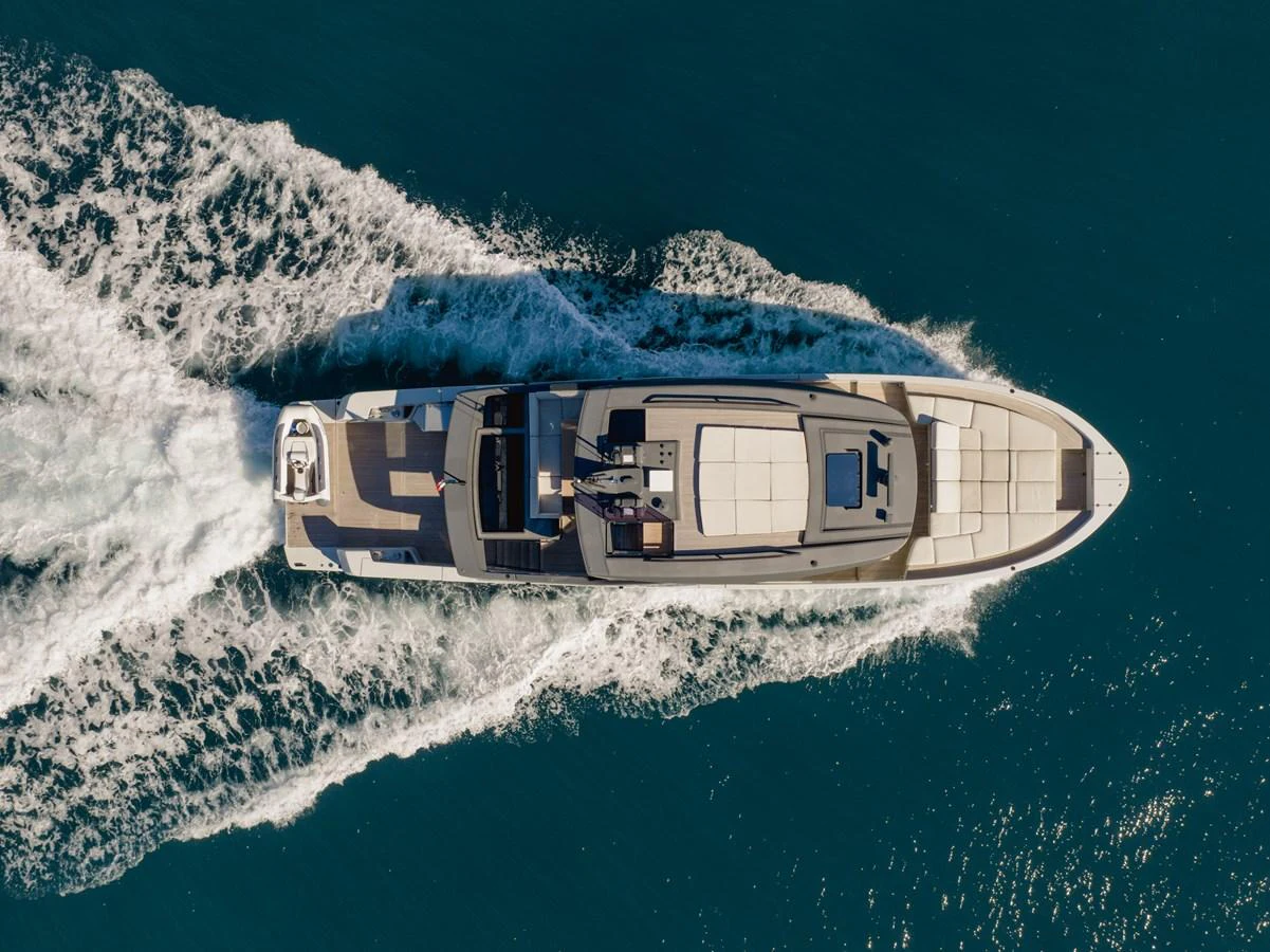 A sleek yacht cruises through the water, showcasing its elegant design from an aerial perspective. aboard EOLINO Yacht for Sale