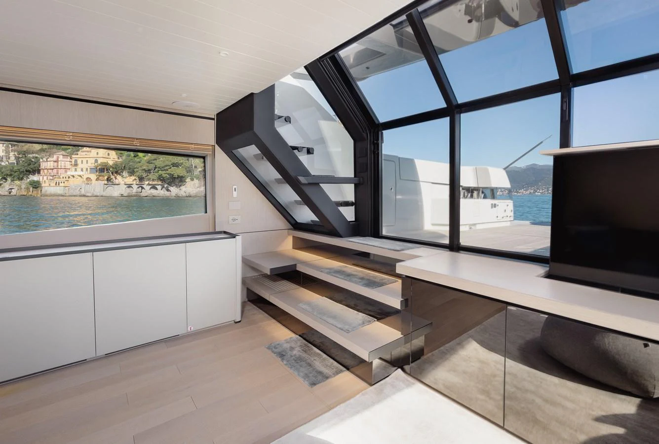 The salon features modern decor with large windows offering stunning sea views. aboard EOLINO Yacht for Sale