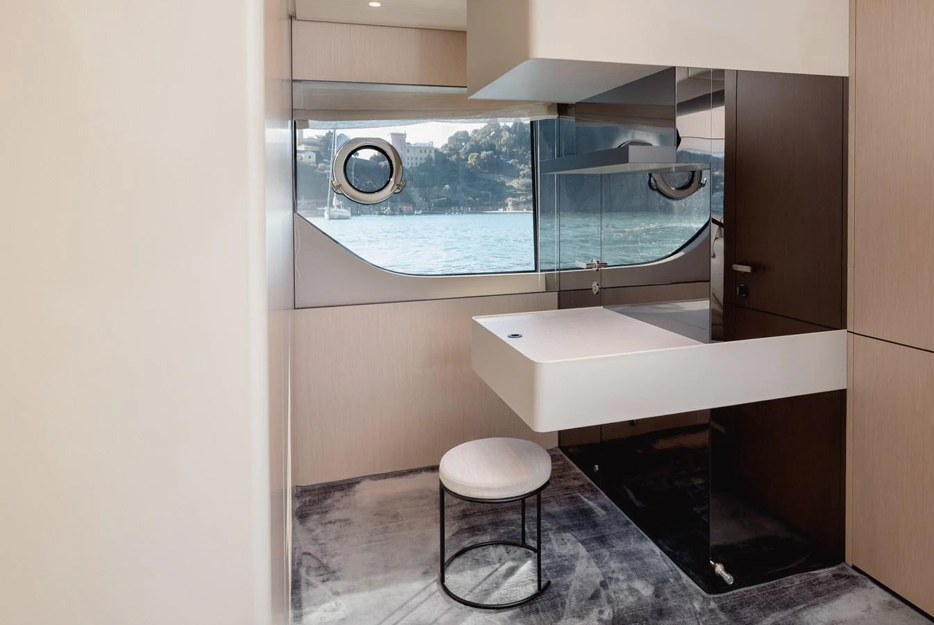 A sleek and modern bathroom with a large window offering a scenic view of the water. aboard EOLINO Yacht for Sale