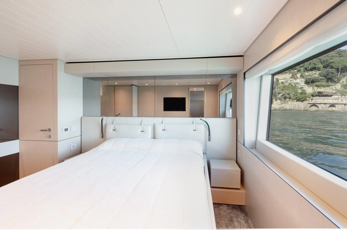 A luxurious stateroom with large windows offering scenic views. aboard EOLINO Yacht for Sale