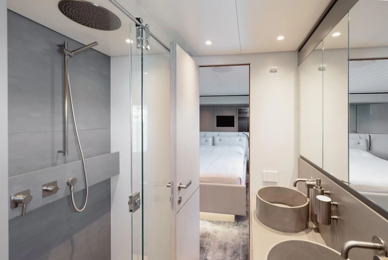 A modern bathroom with a view into a cozy stateroom. aboard EOLINO Yacht for Sale