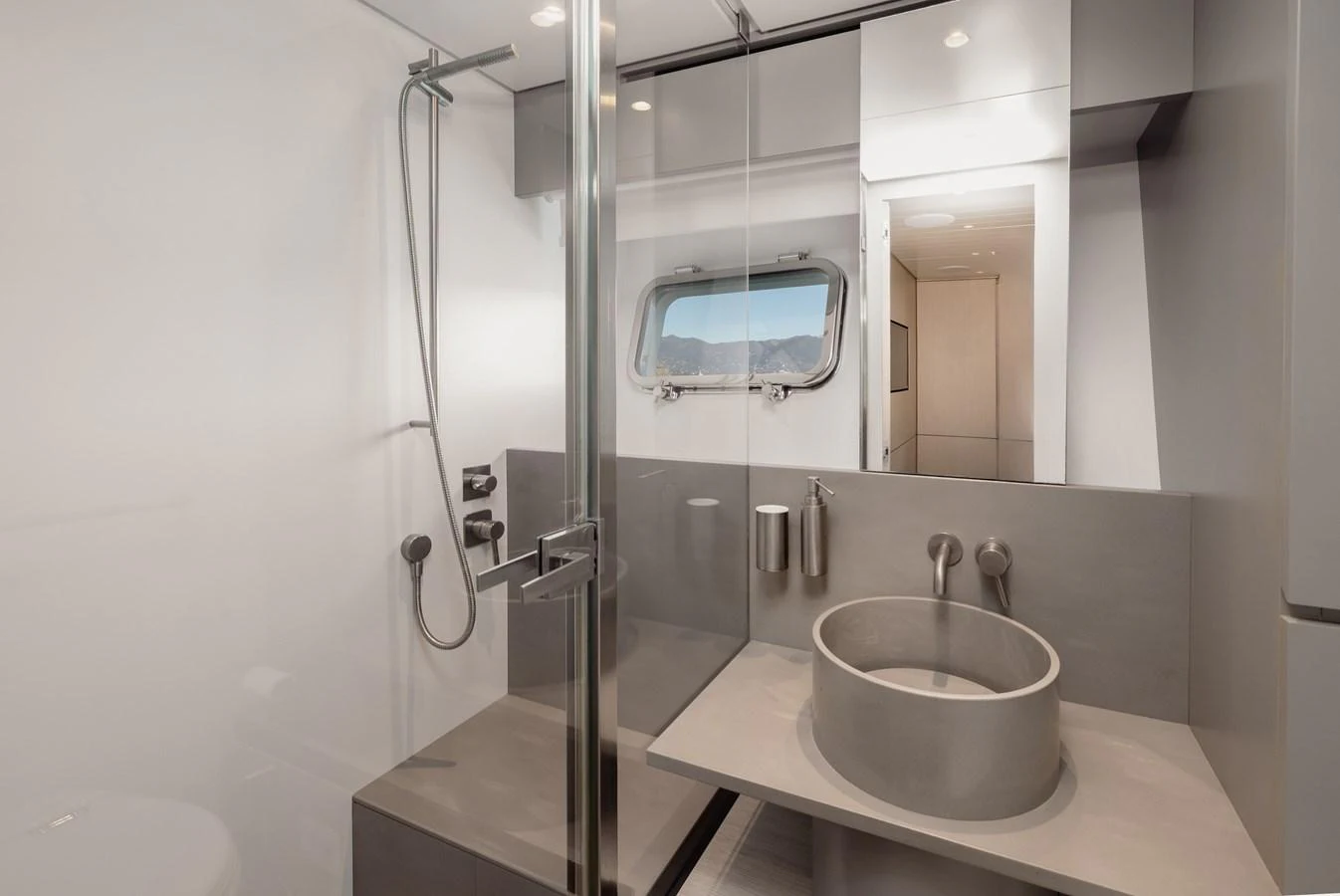 The yacht's bathroom features a modern design with sleek fixtures and a large window providing natural light. aboard EOLINO Yacht for Sale