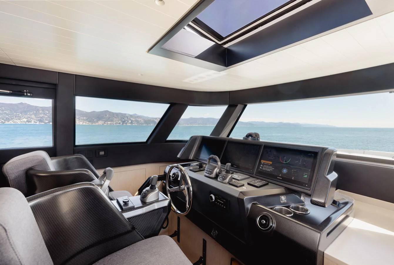The helm station offers a commanding view with state-of-the-art navigation equipment and luxurious seating. aboard EOLINO Yacht for Sale