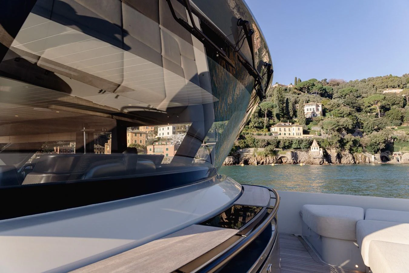 The yacht's sleek exterior design is complemented by a scenic coastal backdrop. aboard EOLINO Yacht for Sale
