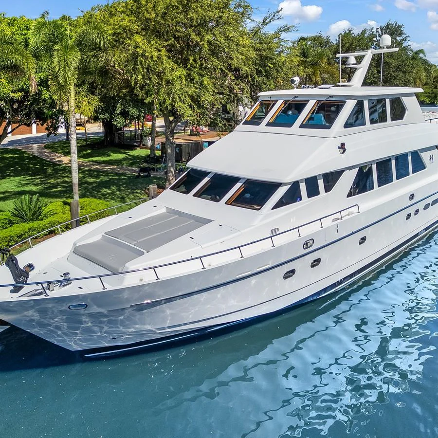 A sleek and modern yacht glides gracefully on the water, showcasing its elegant design and spacious deck. aboard MILES AWEIGH Yacht for Sale