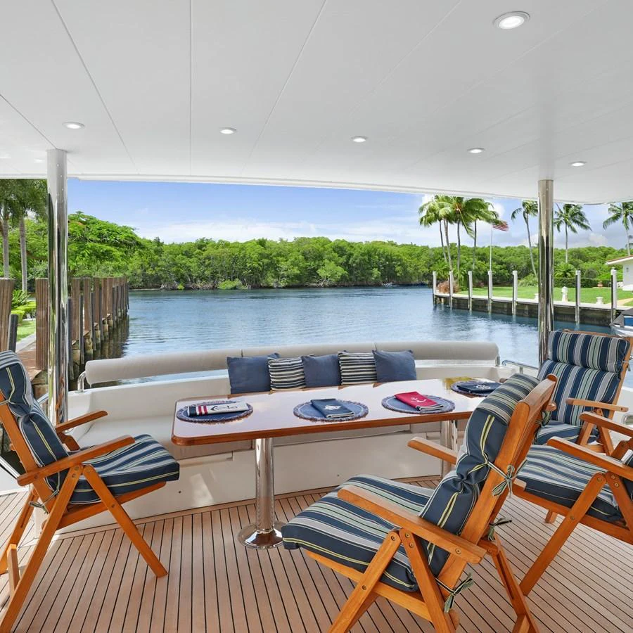 The aft deck offers a comfortable seating area with a scenic view of the water. aboard MILES AWEIGH Yacht for Sale