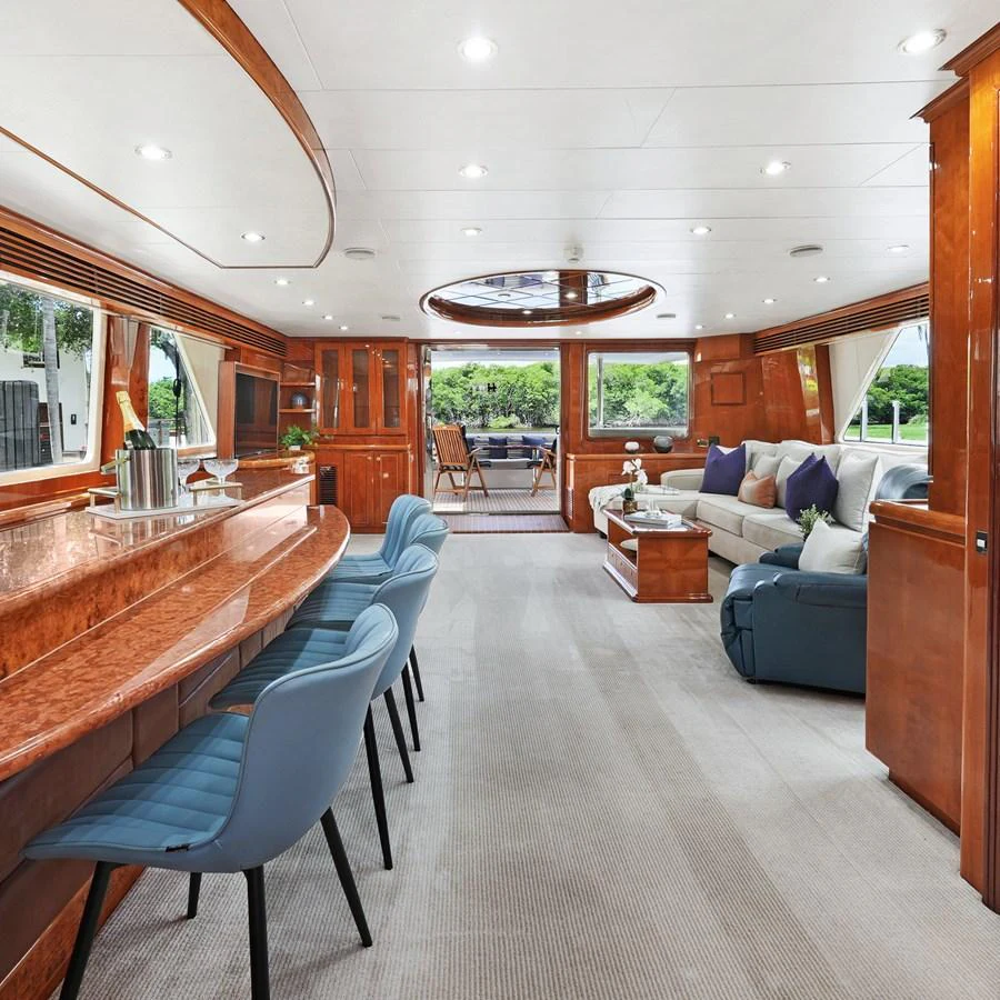 The salon features elegant wood finishes, plush seating, and a stylish bar area, creating a luxurious and inviting atmosphere. aboard MILES AWEIGH Yacht for Sale