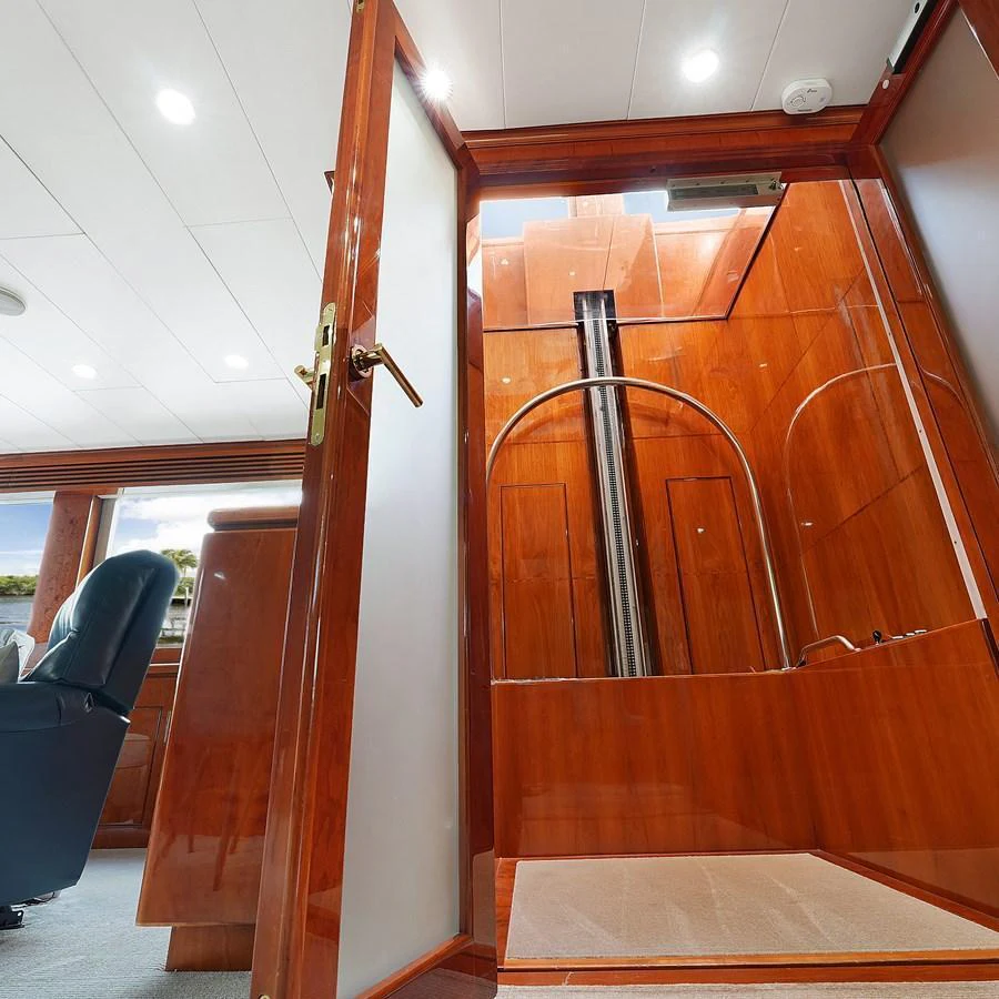 The interior showcases a luxurious wooden finish with a view into a private space. aboard MILES AWEIGH Yacht for Sale